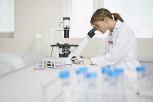 Lab Technician Using Microscope