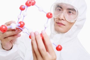 Scientist holding model of molecules